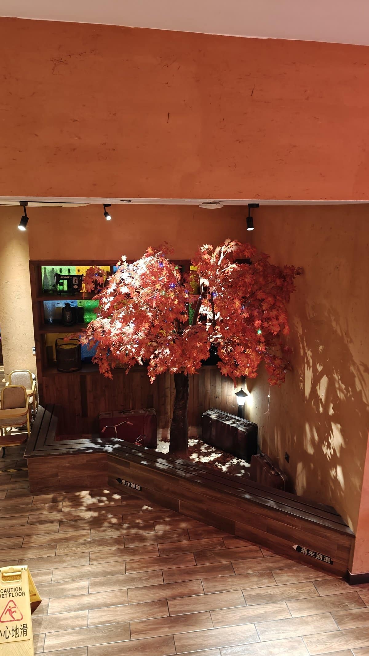 Restaurant entrance lobby with decorative red maple tree,