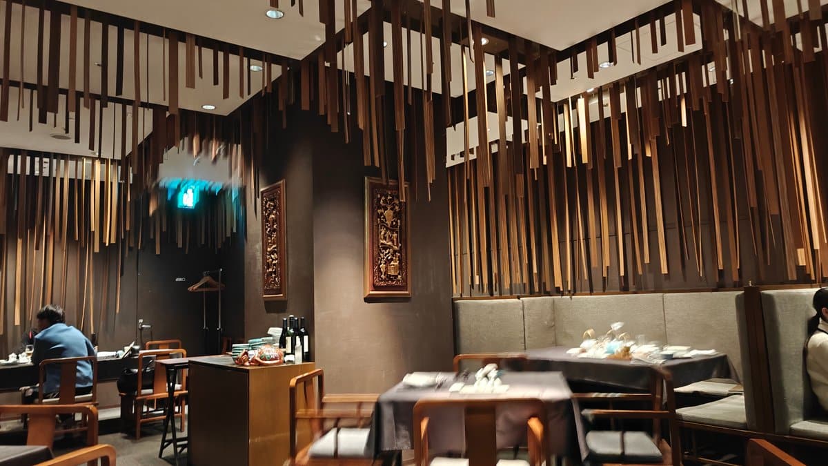 Restaurant interior with modern dark decor, hanging wooden