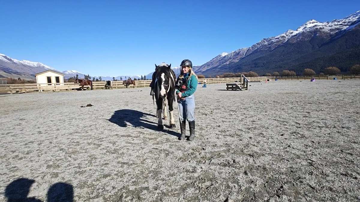 Rider ready beside saddled horse