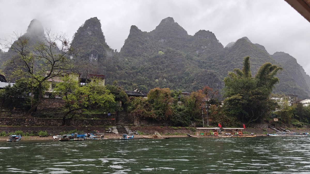 Riverside village under karst peaks