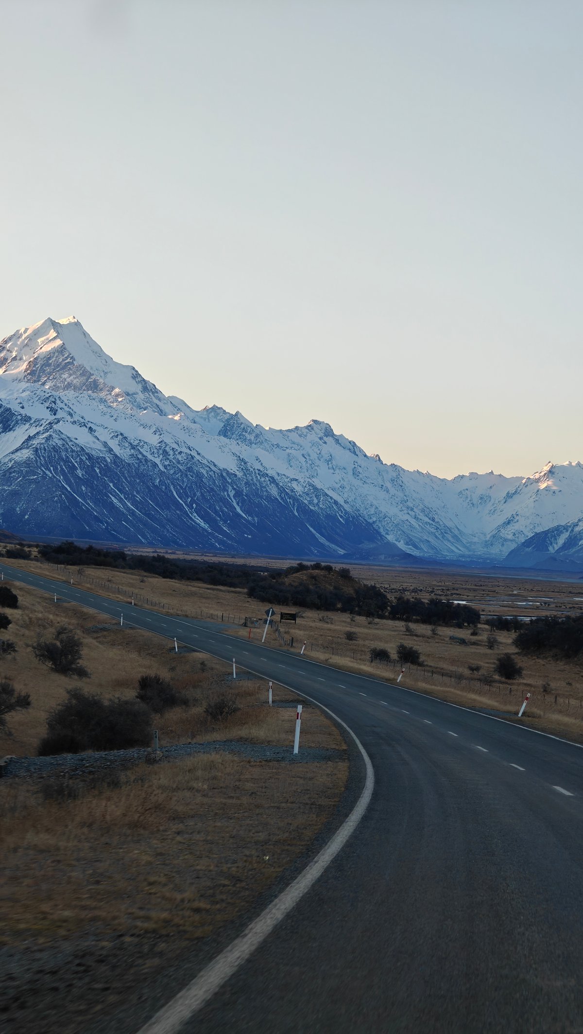 Road aiming at sharp snow peak