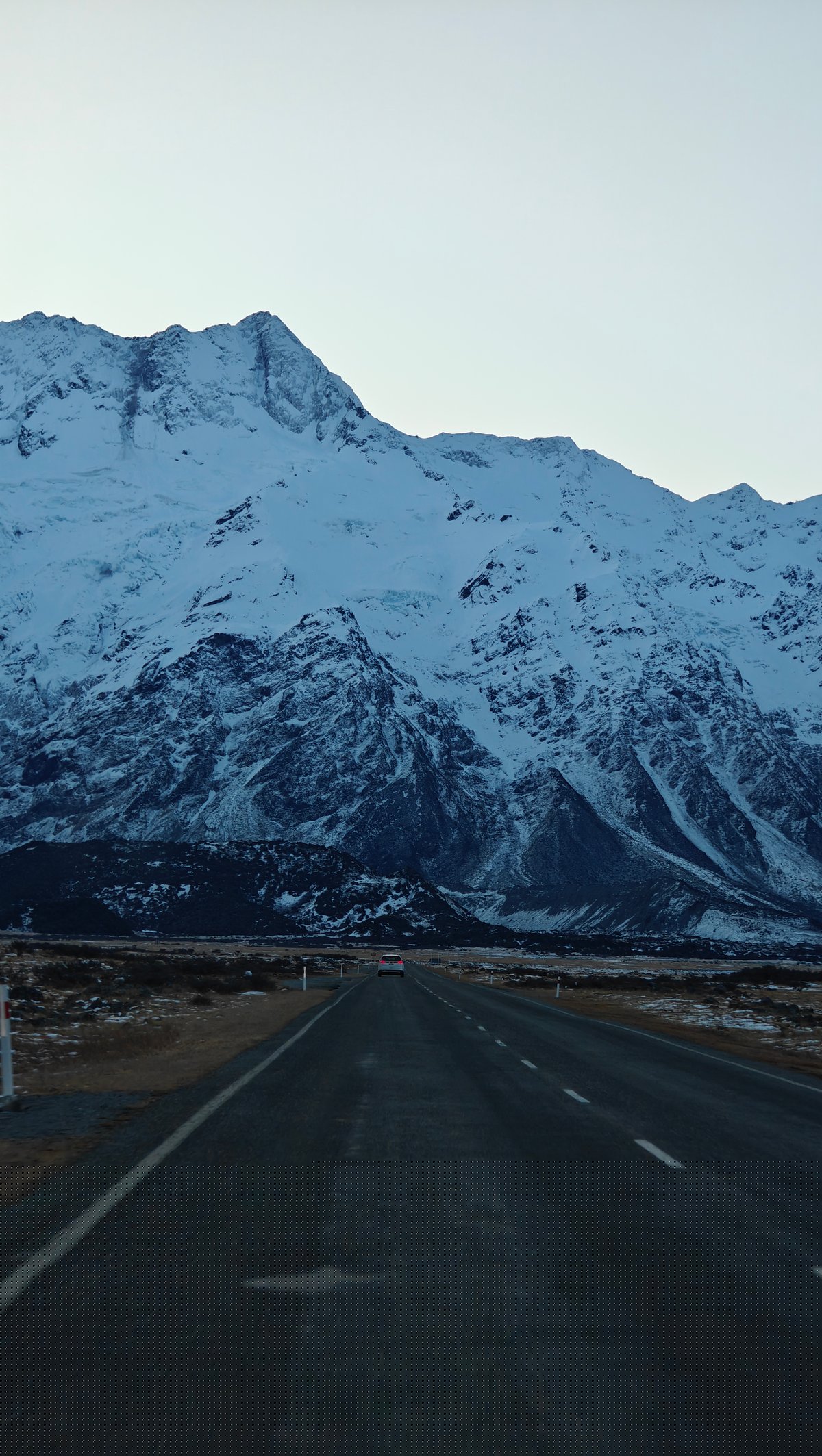 Road heading into dusk mountains