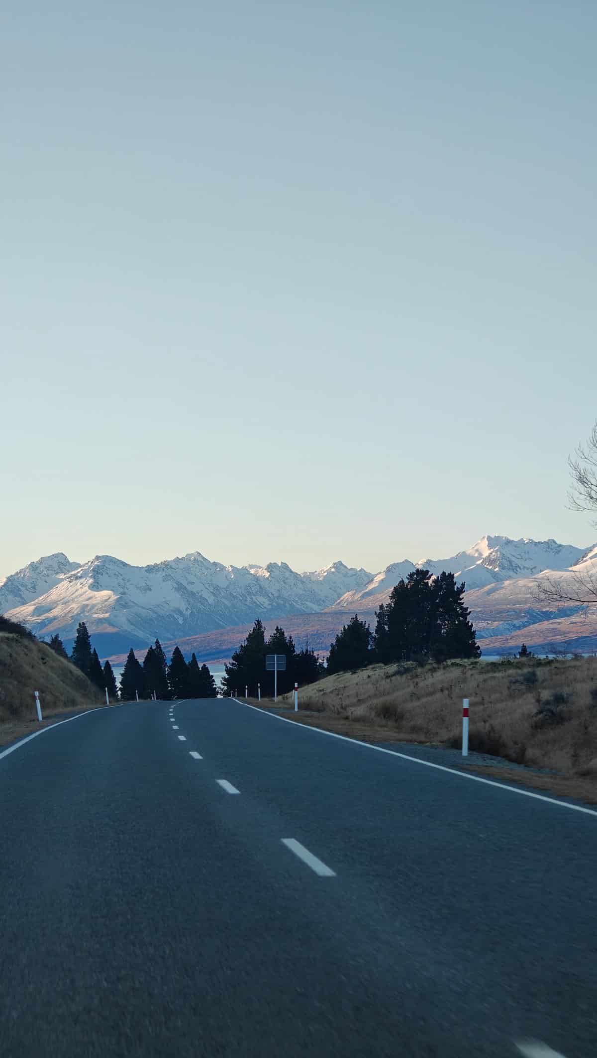 Road running toward a distant snow range at
