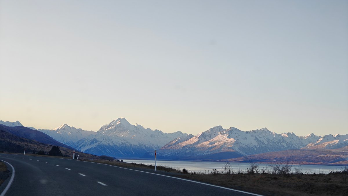 Road sweeping toward alpine lake