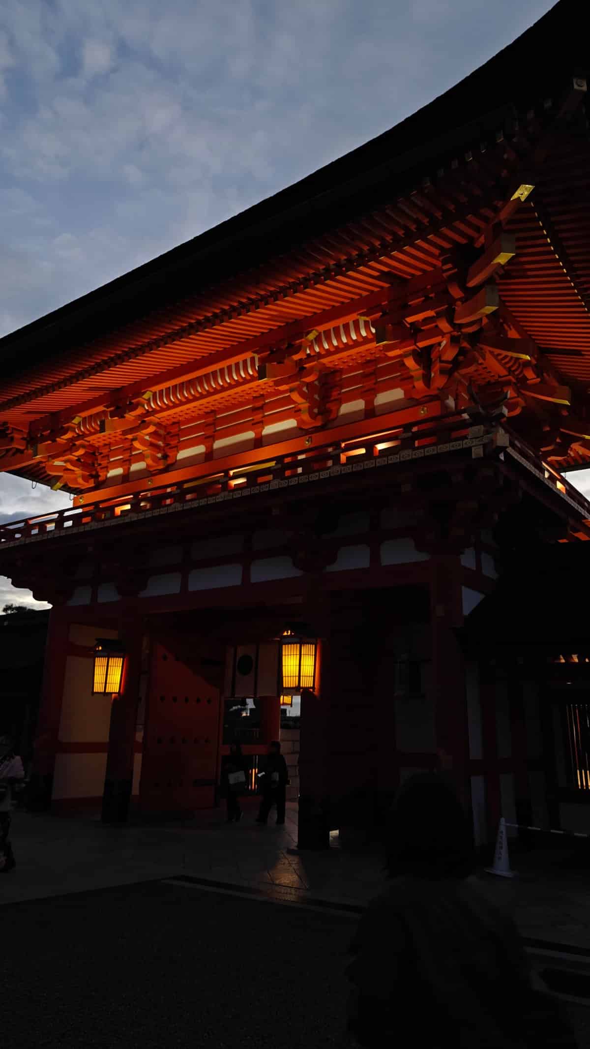 Romon gate lit against night sky