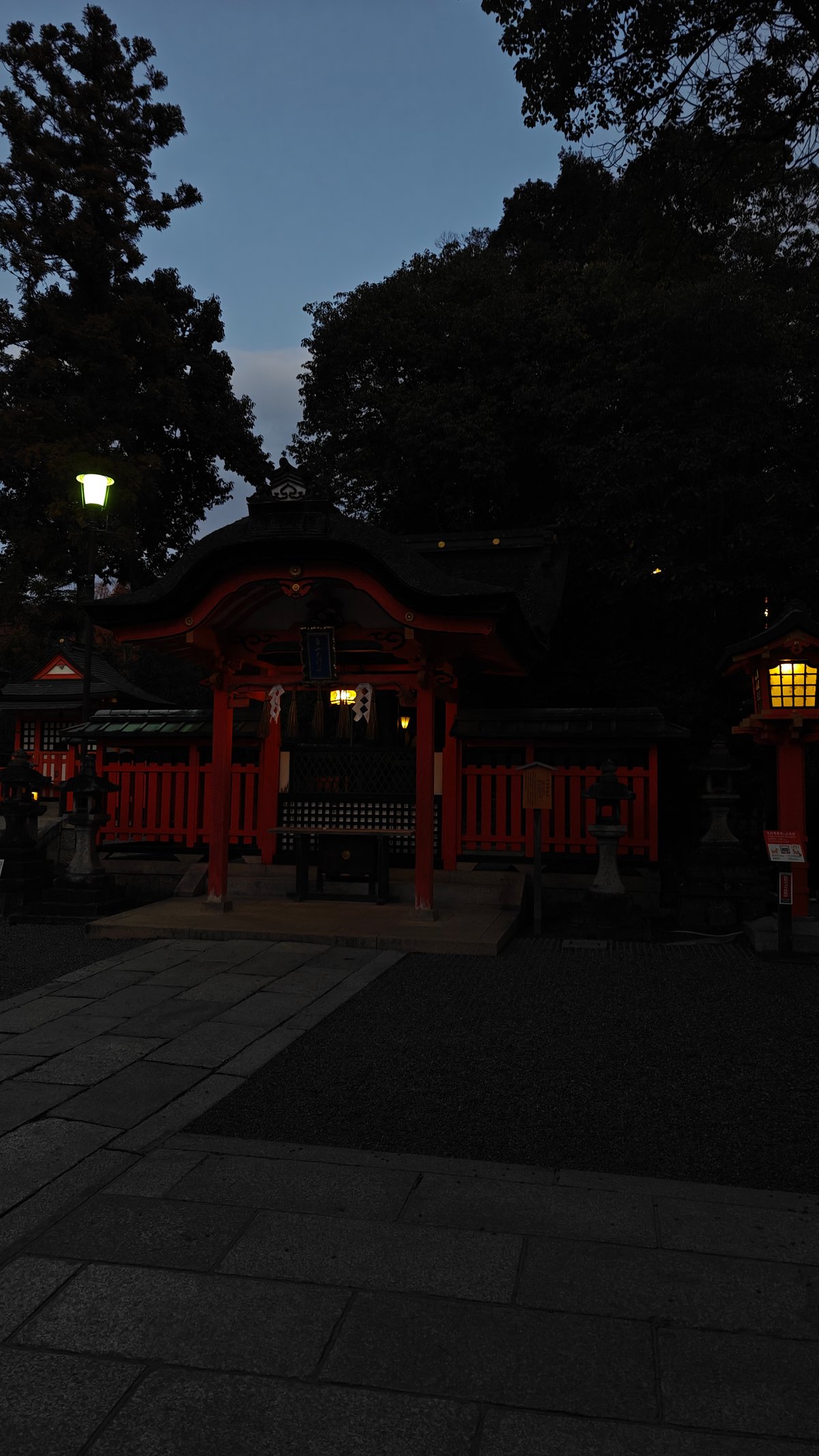 Shrine building at dusk with a glowing lantern