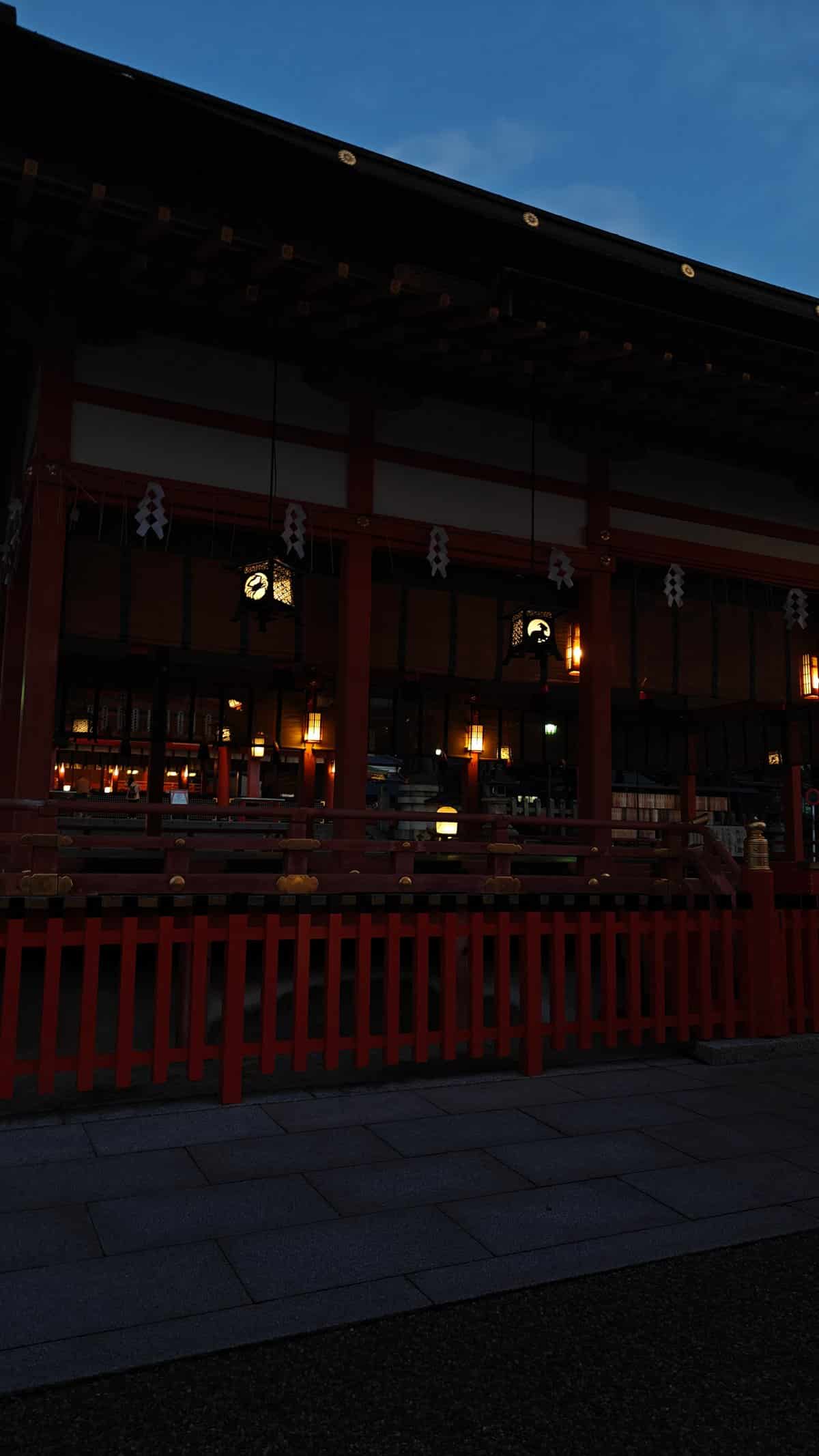 Shrine buildings with hanging lanterns at nightfall