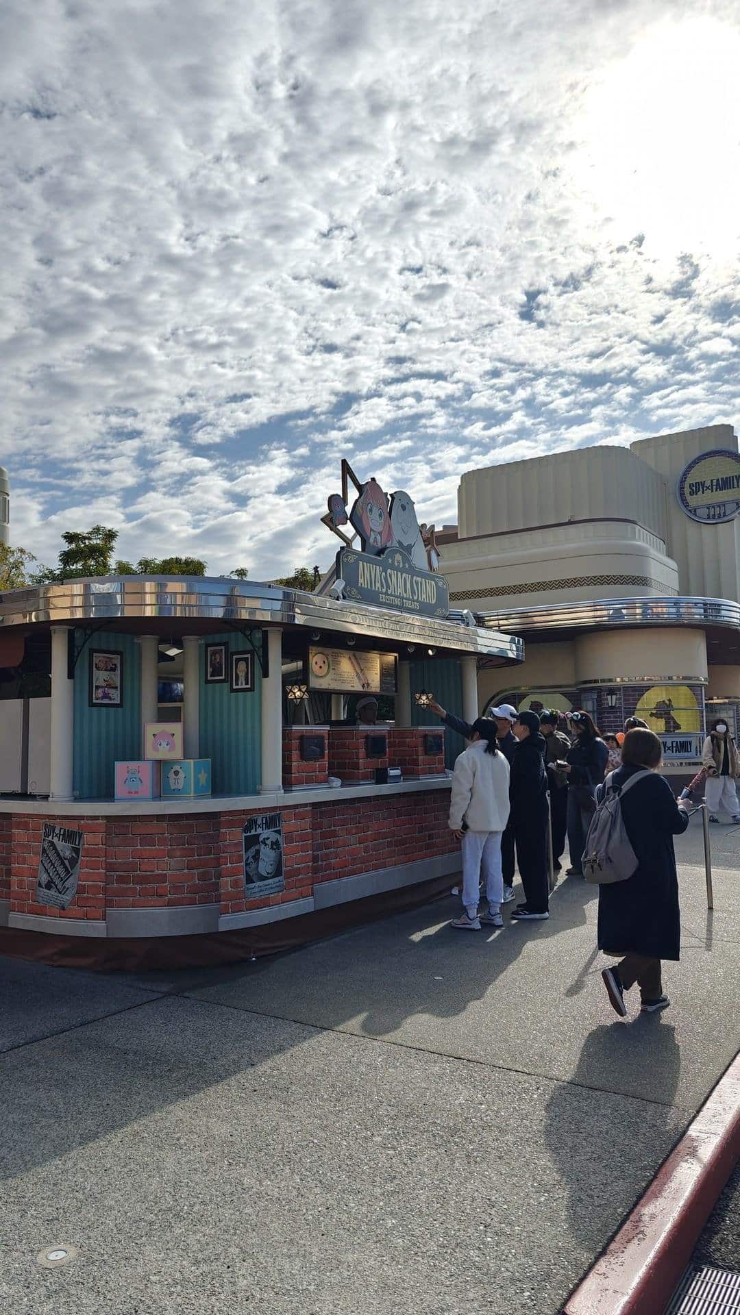 Snack stand with people and cloudy sky