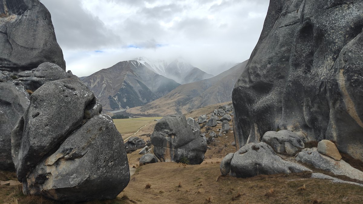 Snow mountain framed by boulders
