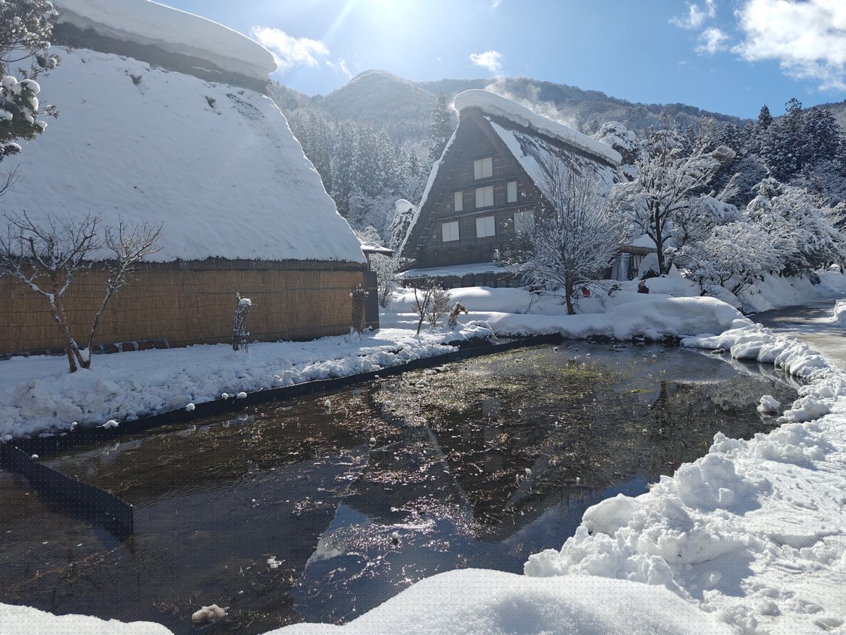 Snowy house canal reflection