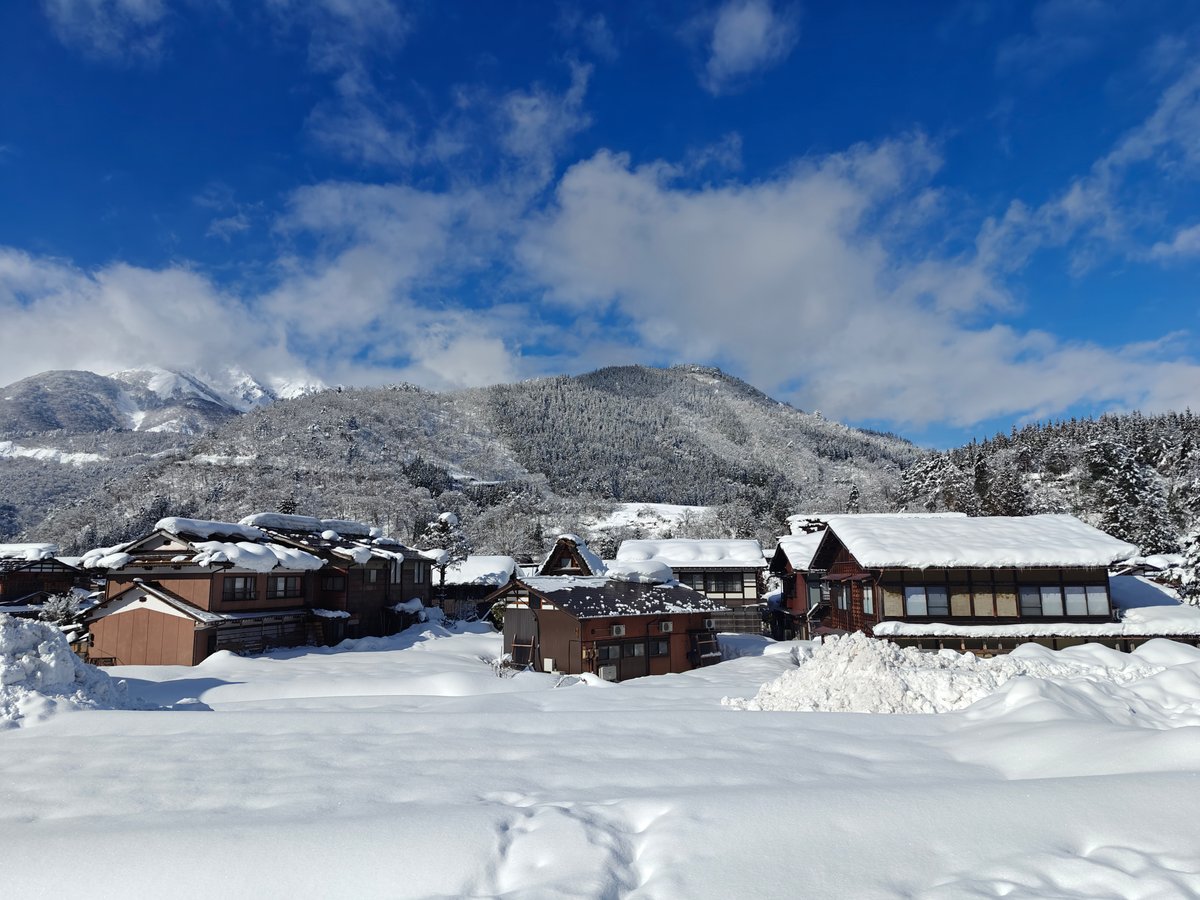 Snowy village cluster and mountains