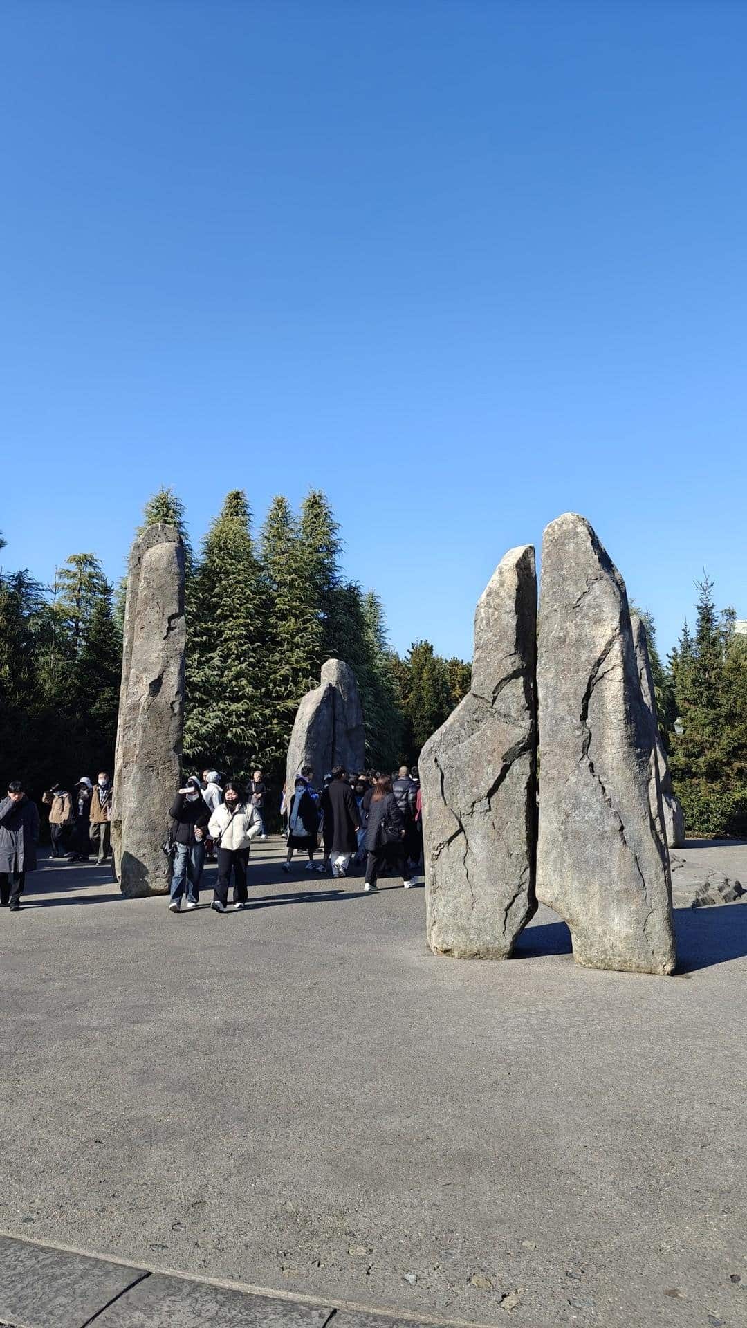 Stone monuments with people and trees