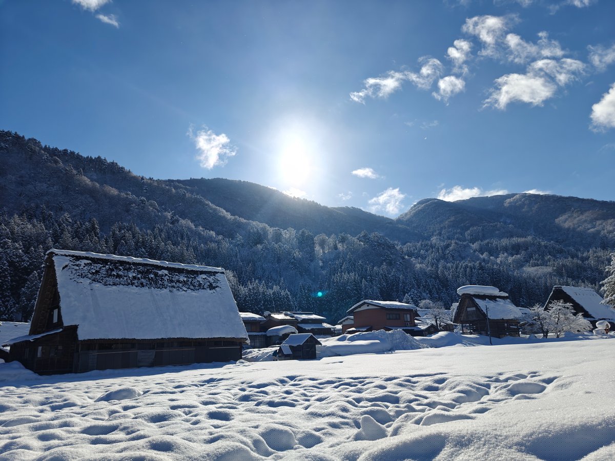 Sun flare on snowy gassho roof