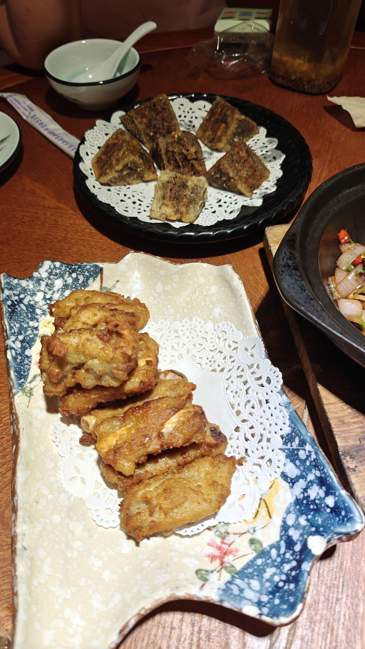 Table spread showing fried meat pieces on blue-and-white