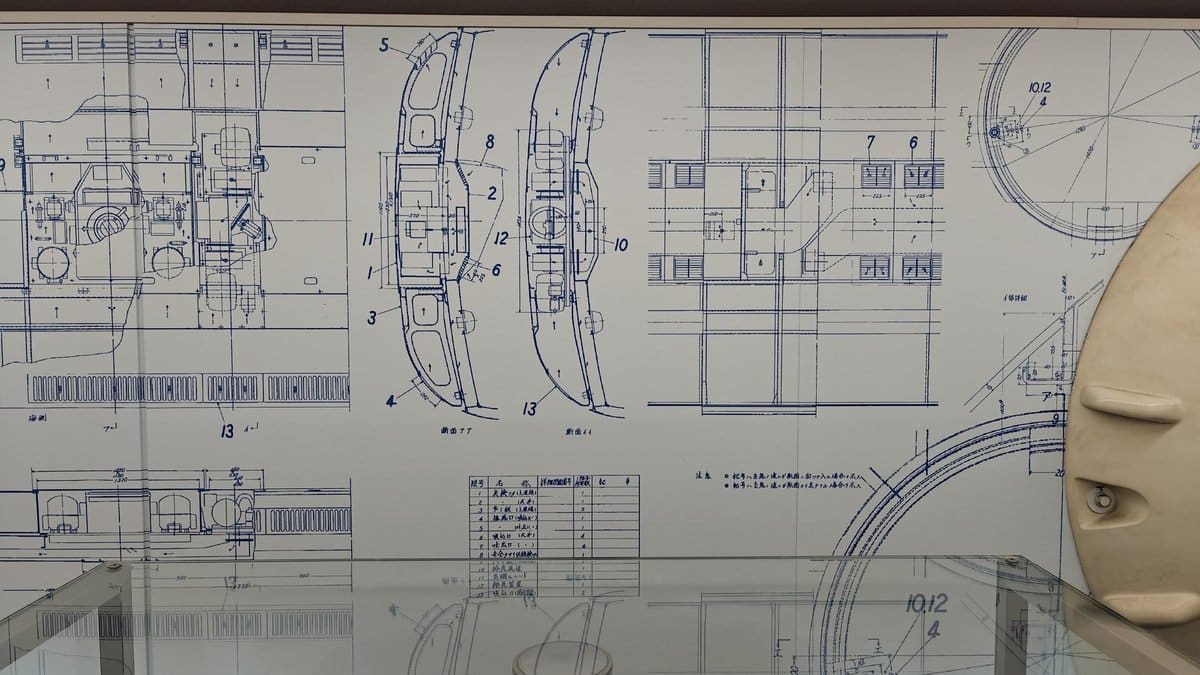 Technical schematics on display wall