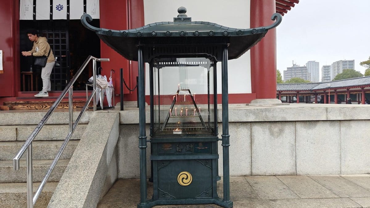 Temple incense burner and praying person