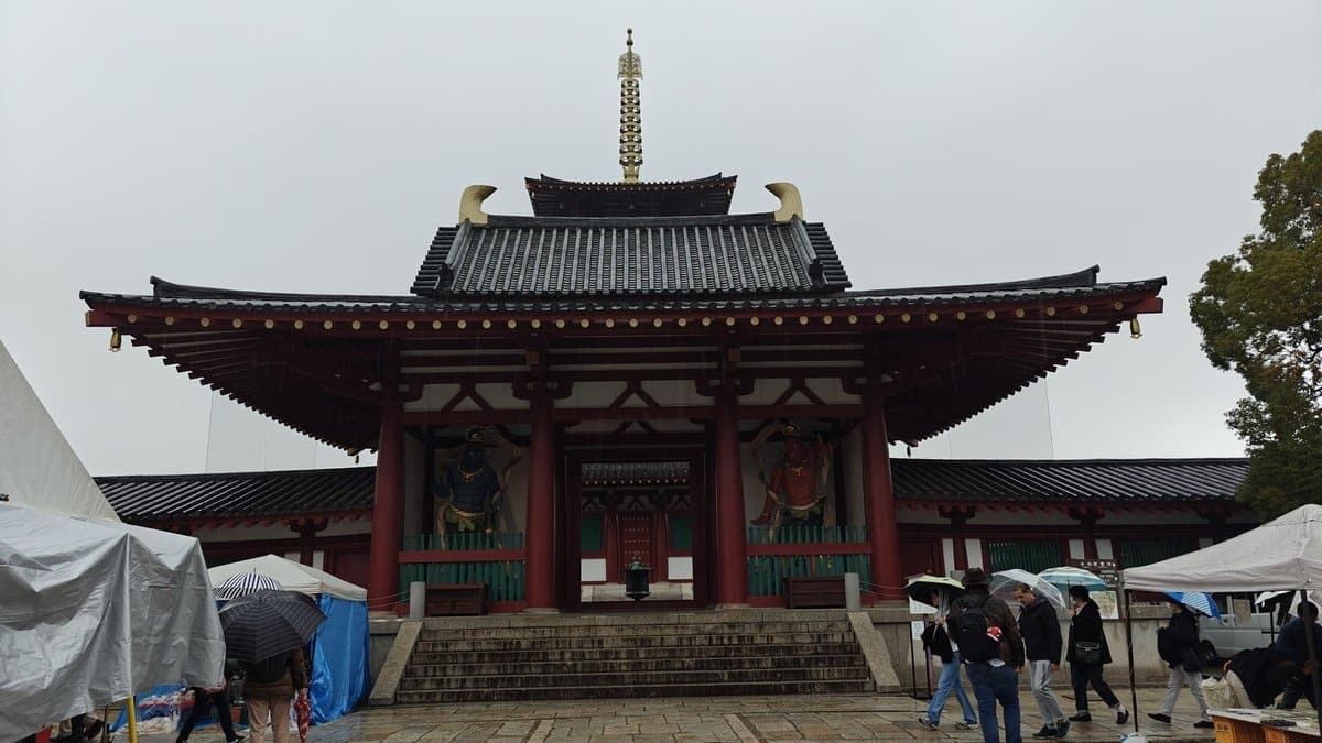 Temple with visitors using umbrellas