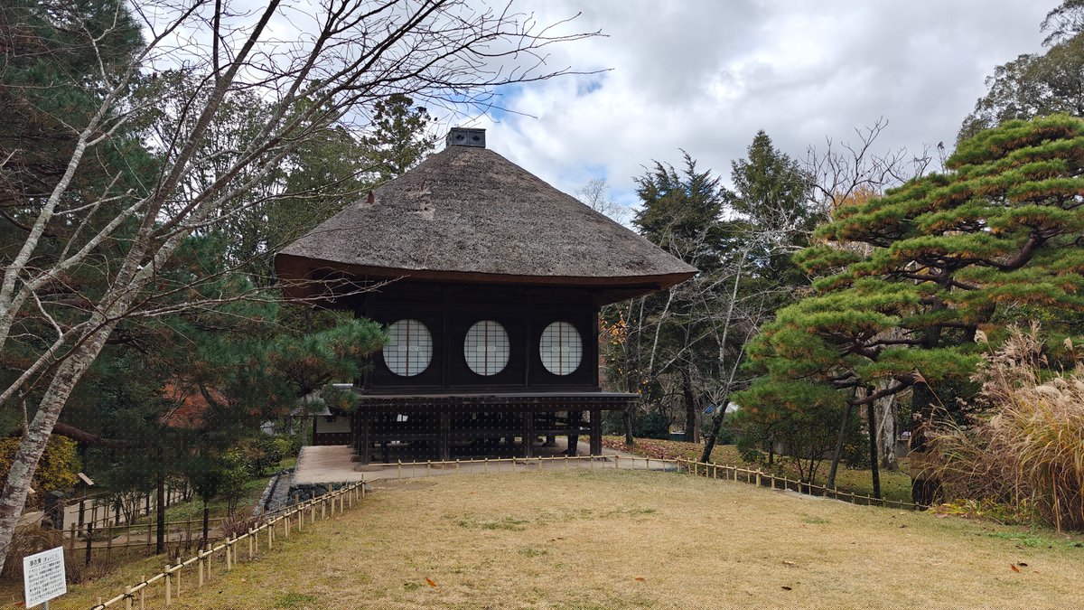 Thatched pavilion on grassy hill