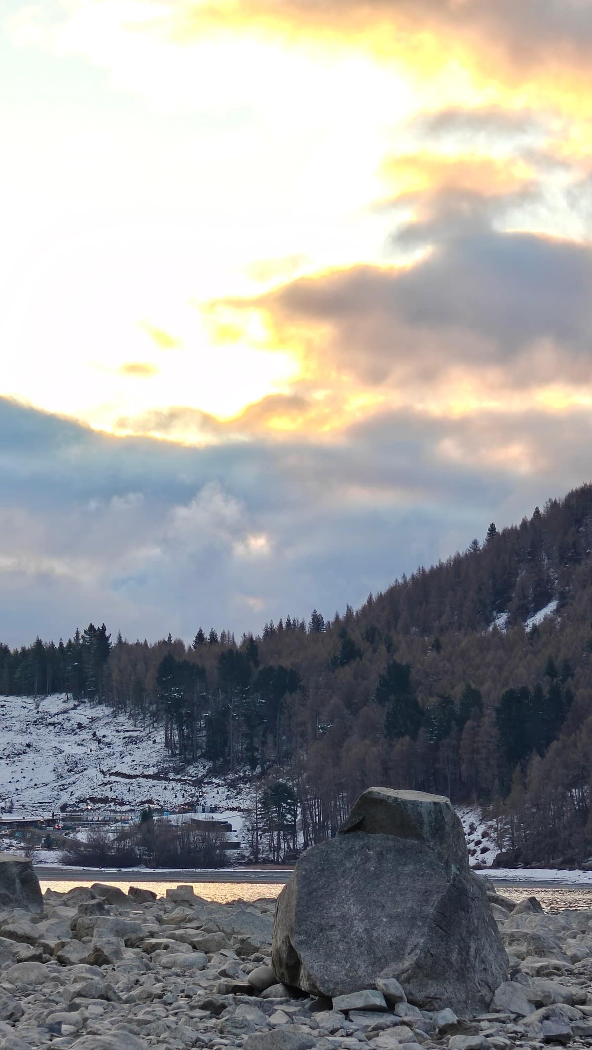 The sun breaking through heavy cloud over the