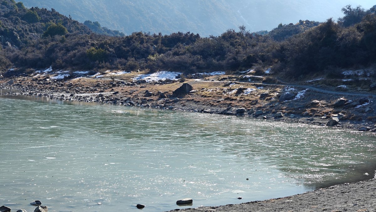 The tarn with its moraine shoreline and mountains