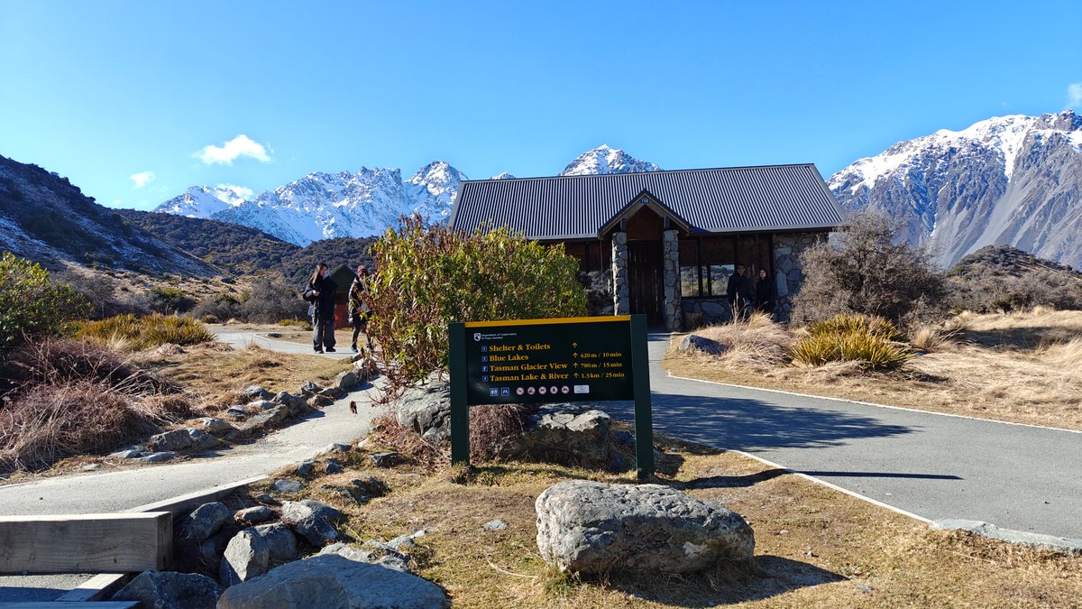 The trailhead shelter and directional sign with a