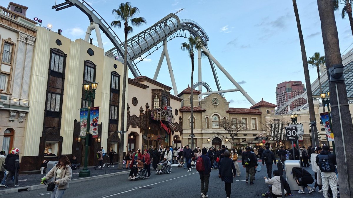 Theme park street with roller coaster