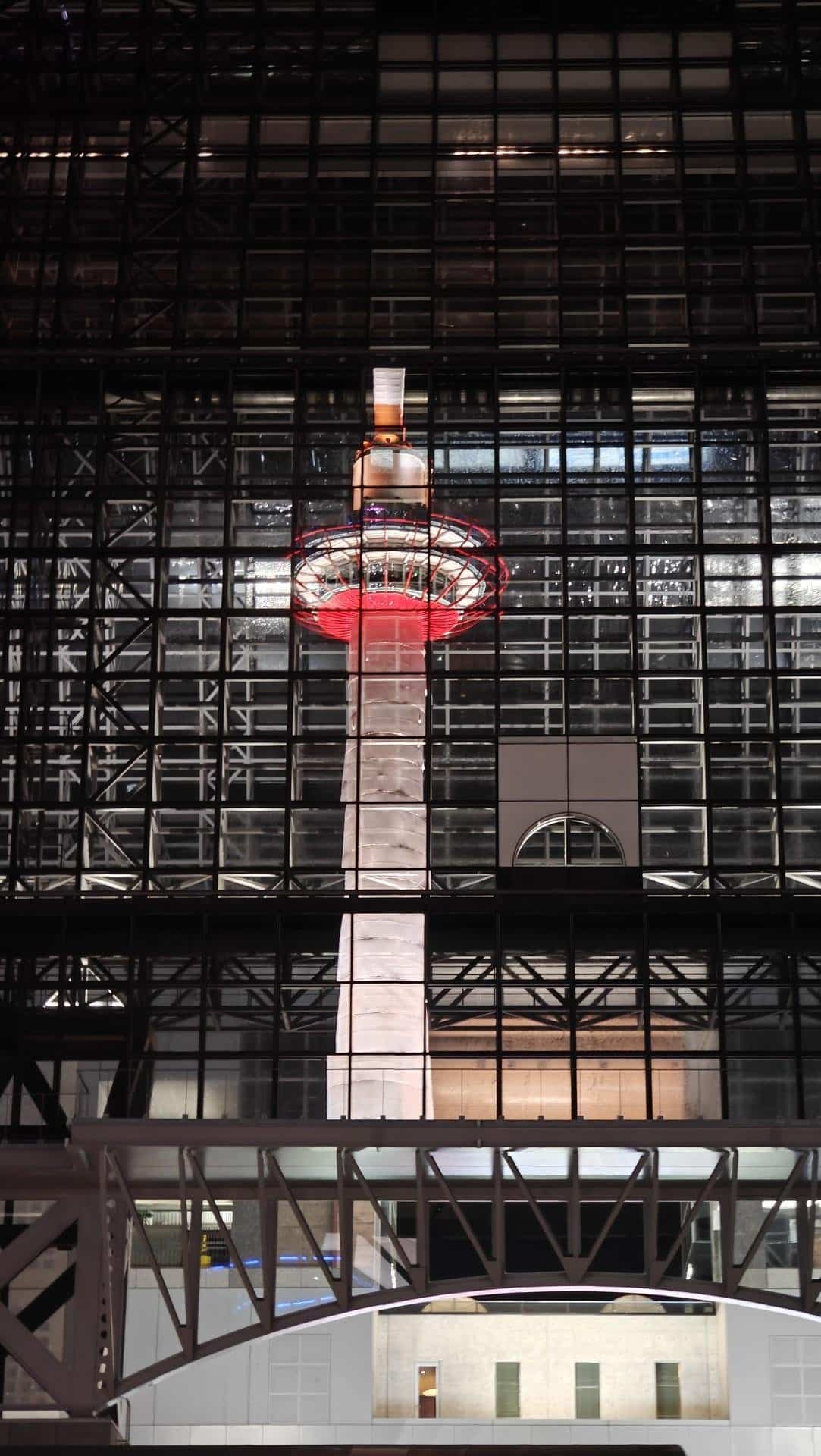 Tower through window grid at night