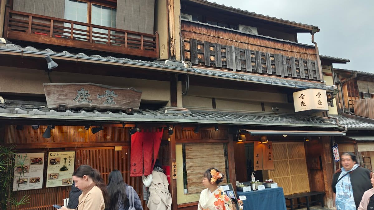 Traditional wooden machiya building exterior with visitors