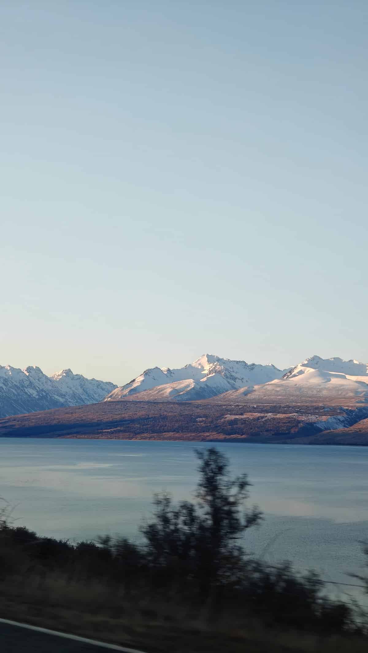Turquoise glacial lake backed by snow peaks, a
