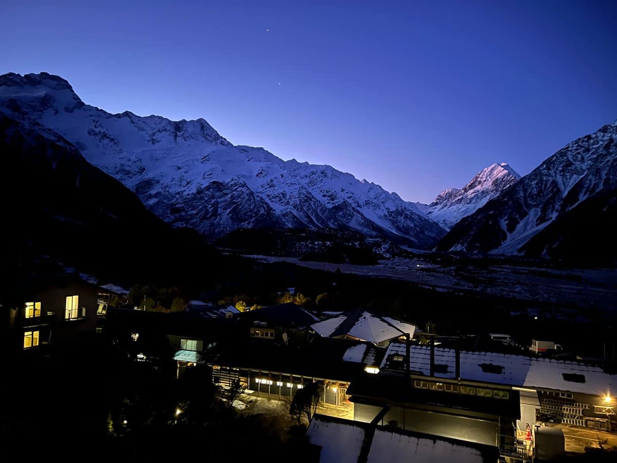 Twilight peaks above the lit buildings of Mount