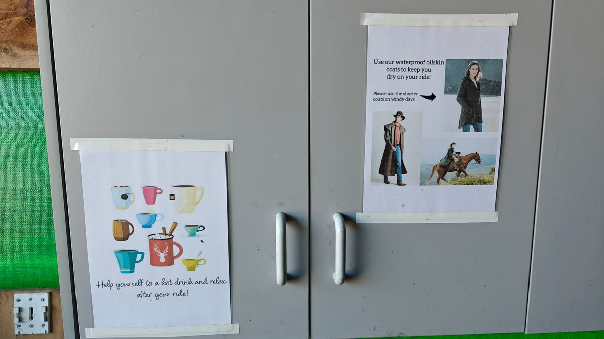 Two hand-taped posters on a grey cabinet in