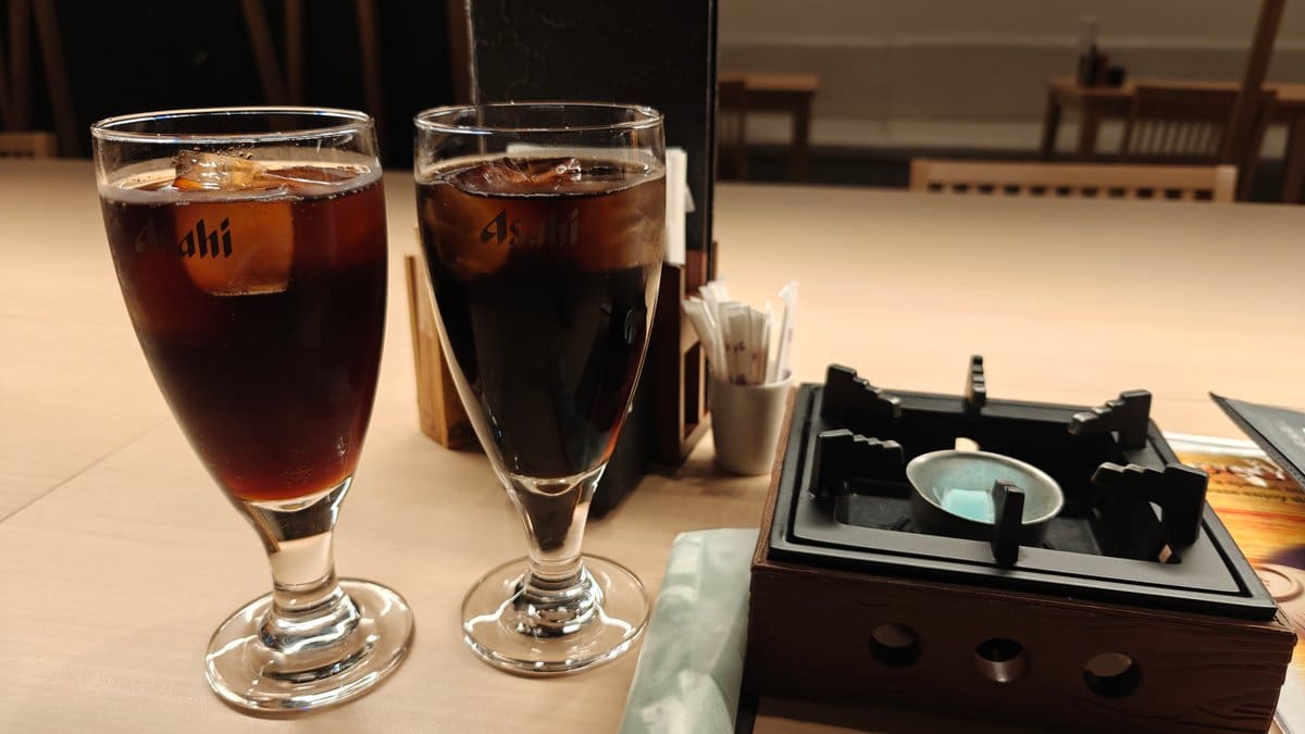 Two iced drinks and a tabletop gas burner