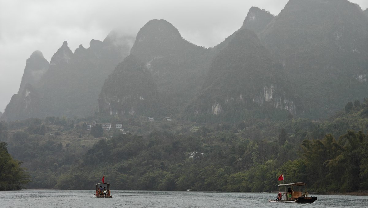 Two rafts before mountain range
