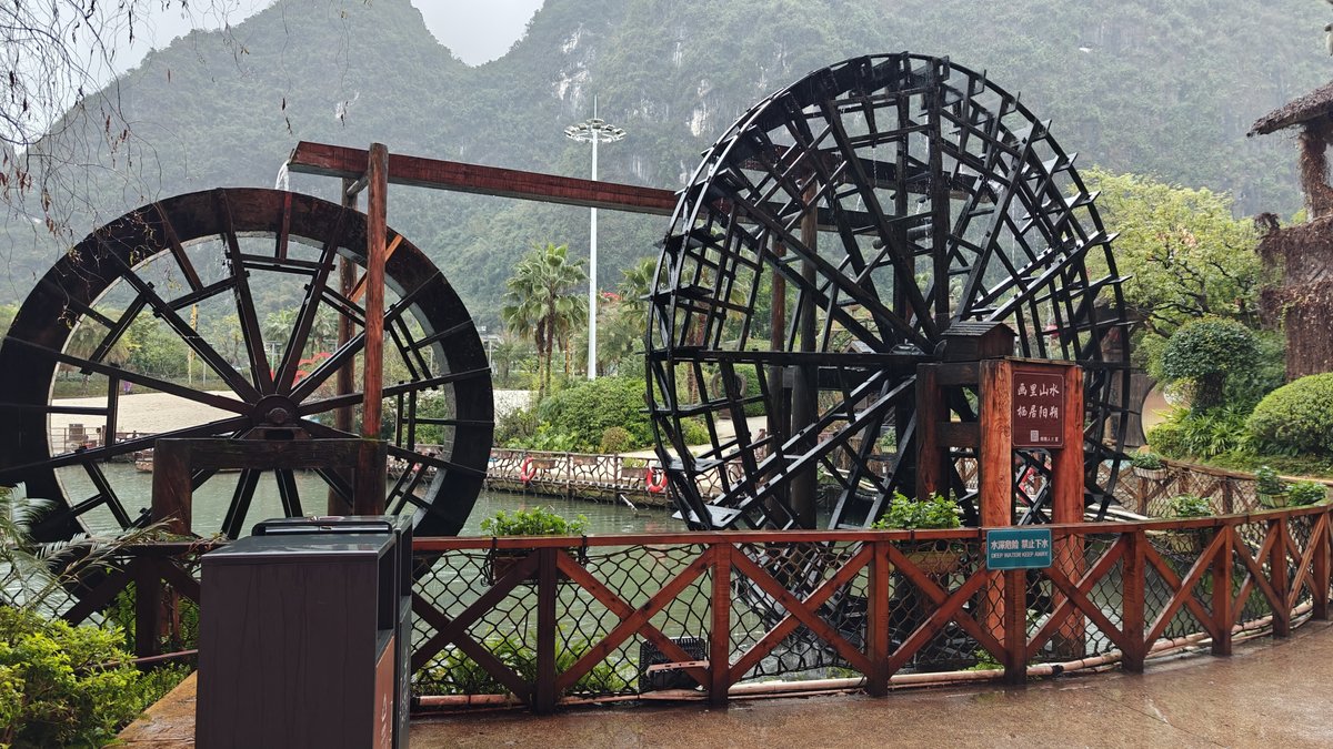 Two water wheels lake mist