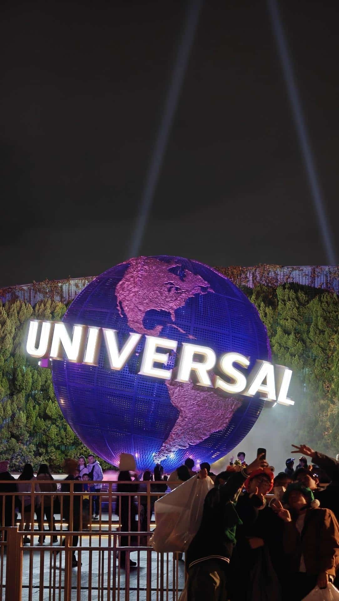 Universal globe night scene with crowd