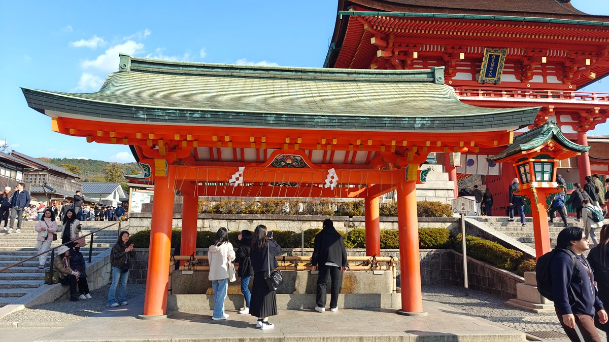 Vermilion shrine hall with a copper-green roof and