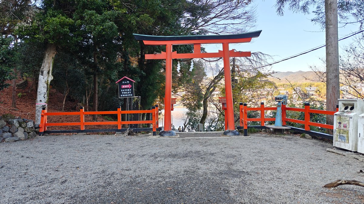 Vermilion torii and shrine buildings on the hillside