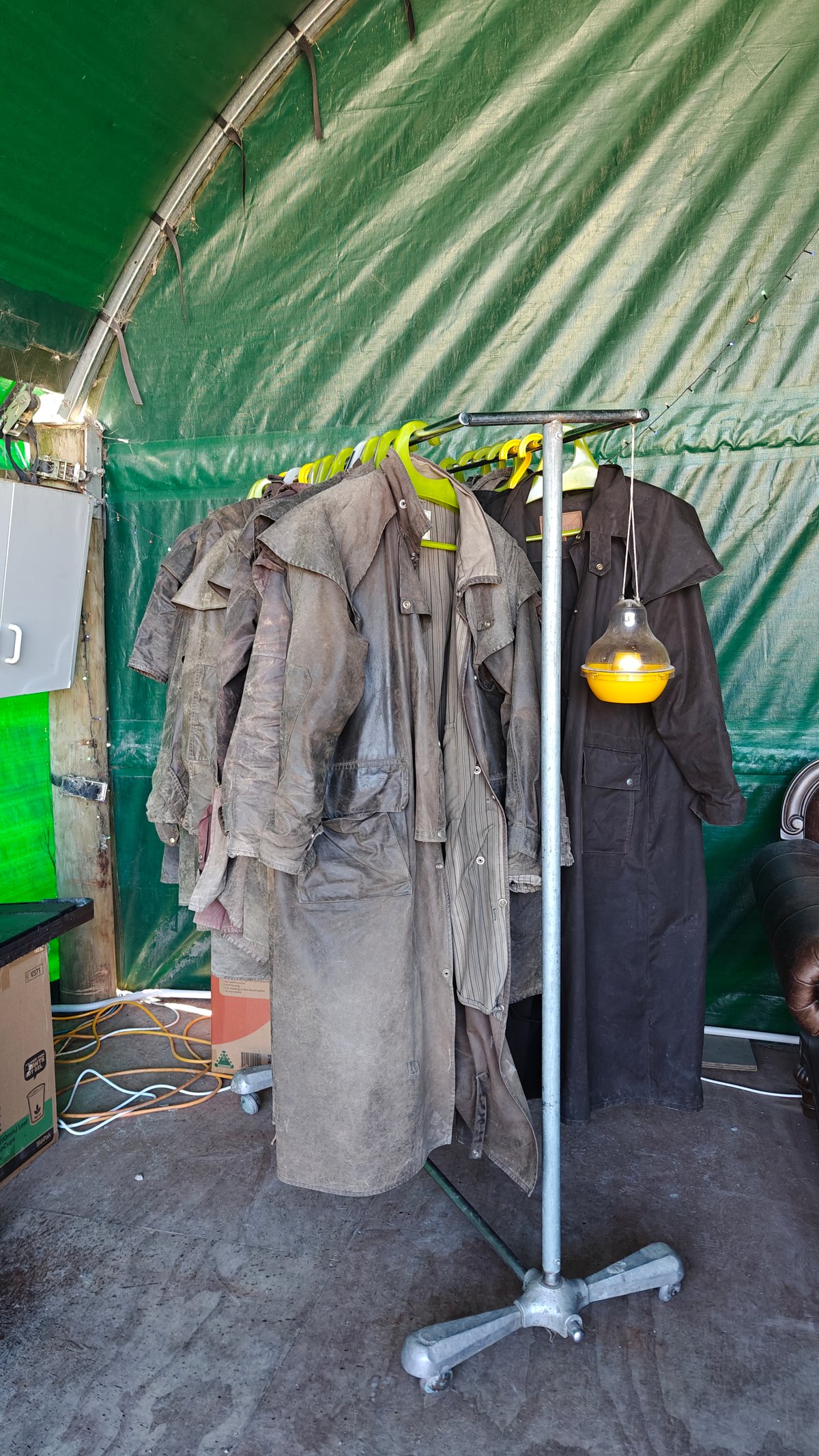 Vertical shot of the waxed oilskin coats hanging