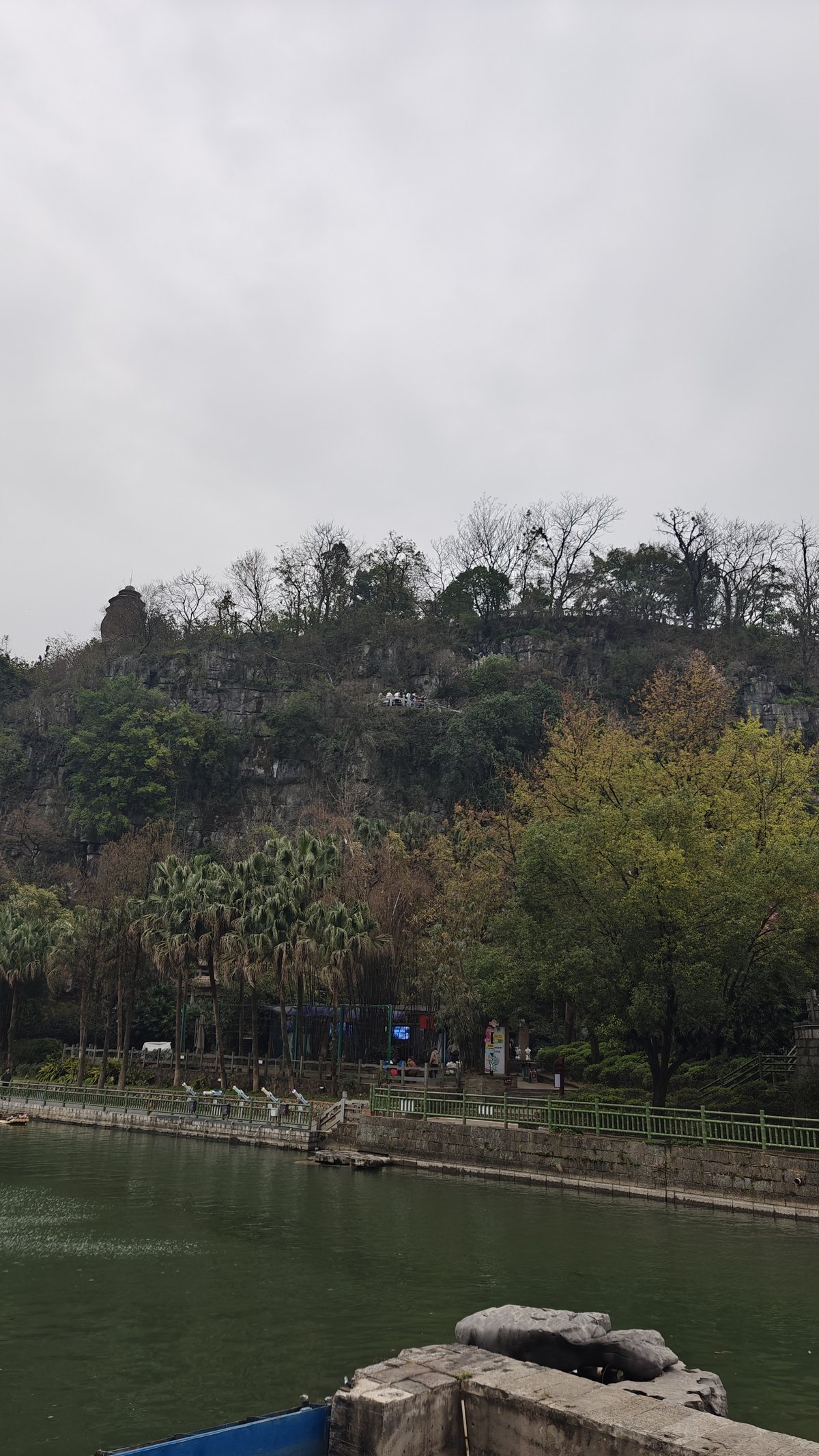 View across river to karst hillside with pagoda