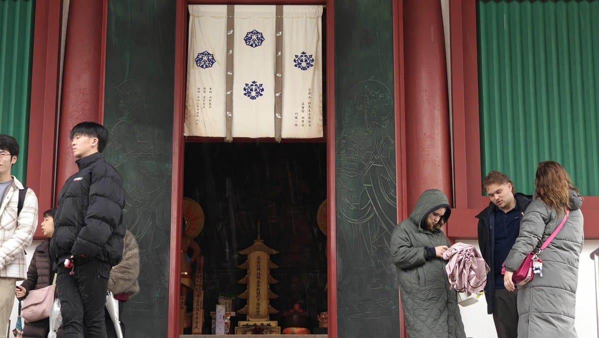 Visitors outside a temple entrance