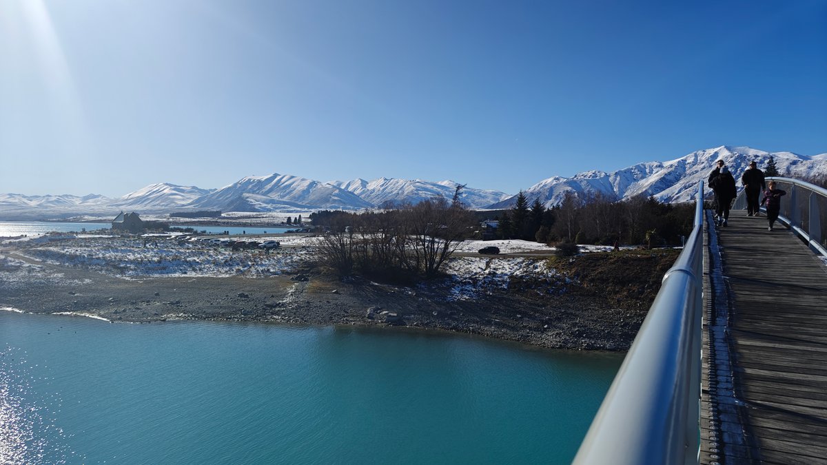 Walking out across the Lake Tekapo footbridge over