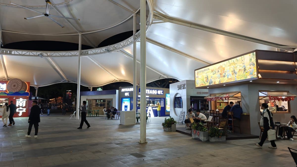 Walkway with shops, cafés, and food stalls along