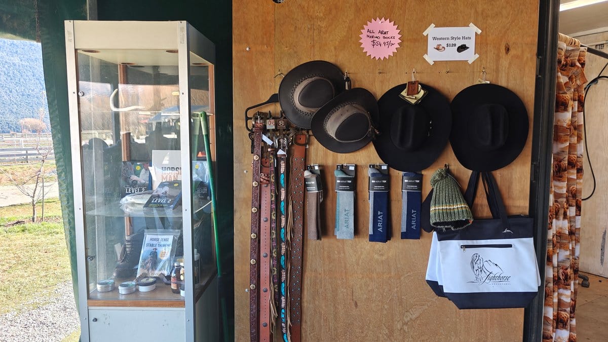 Wall display of riding hats and crops hanging