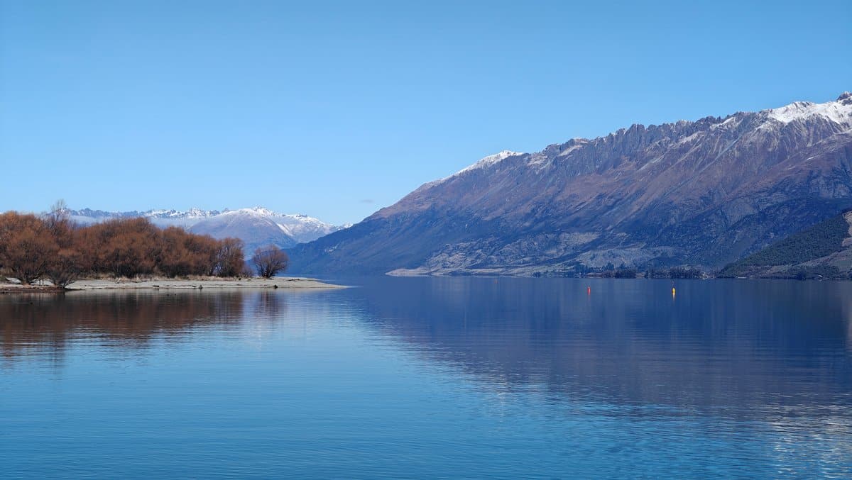 Wide calm lake mountain vista