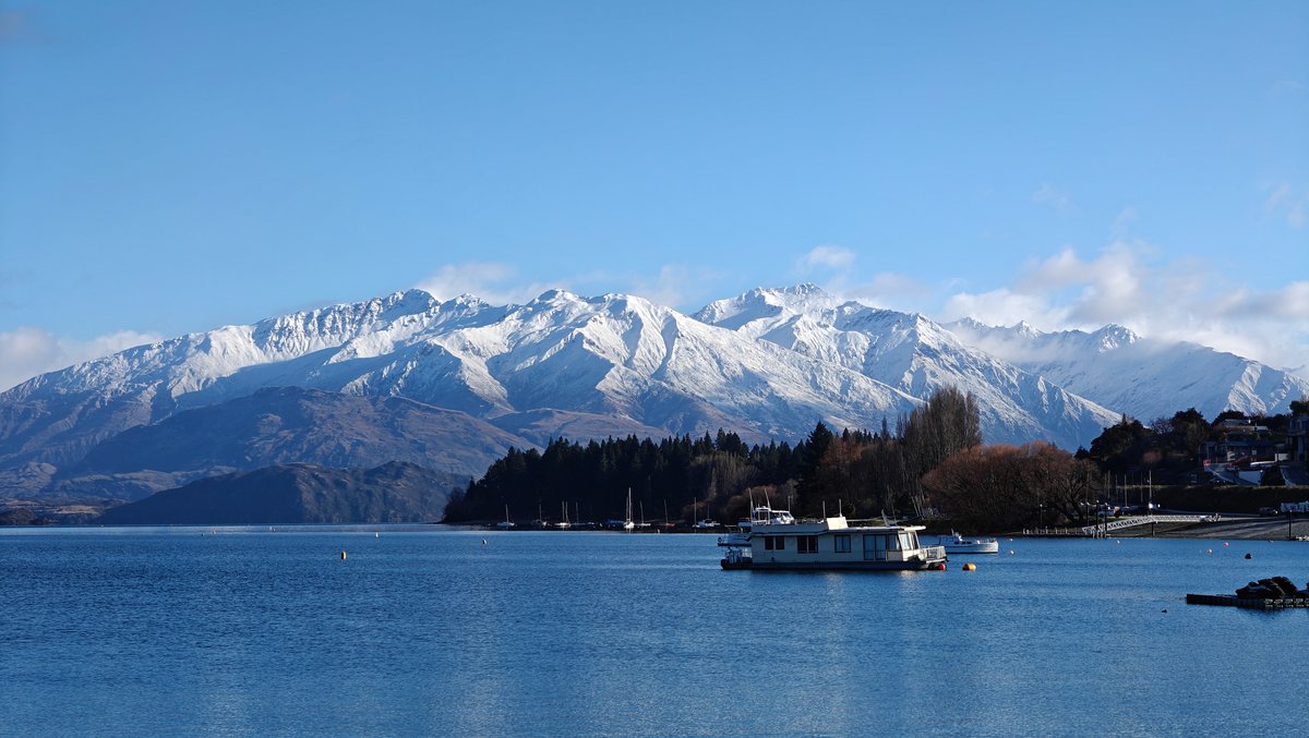 Wide lakefront view with a houseboat on the