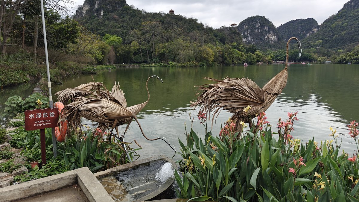 Wooden bird sculptures mountain background