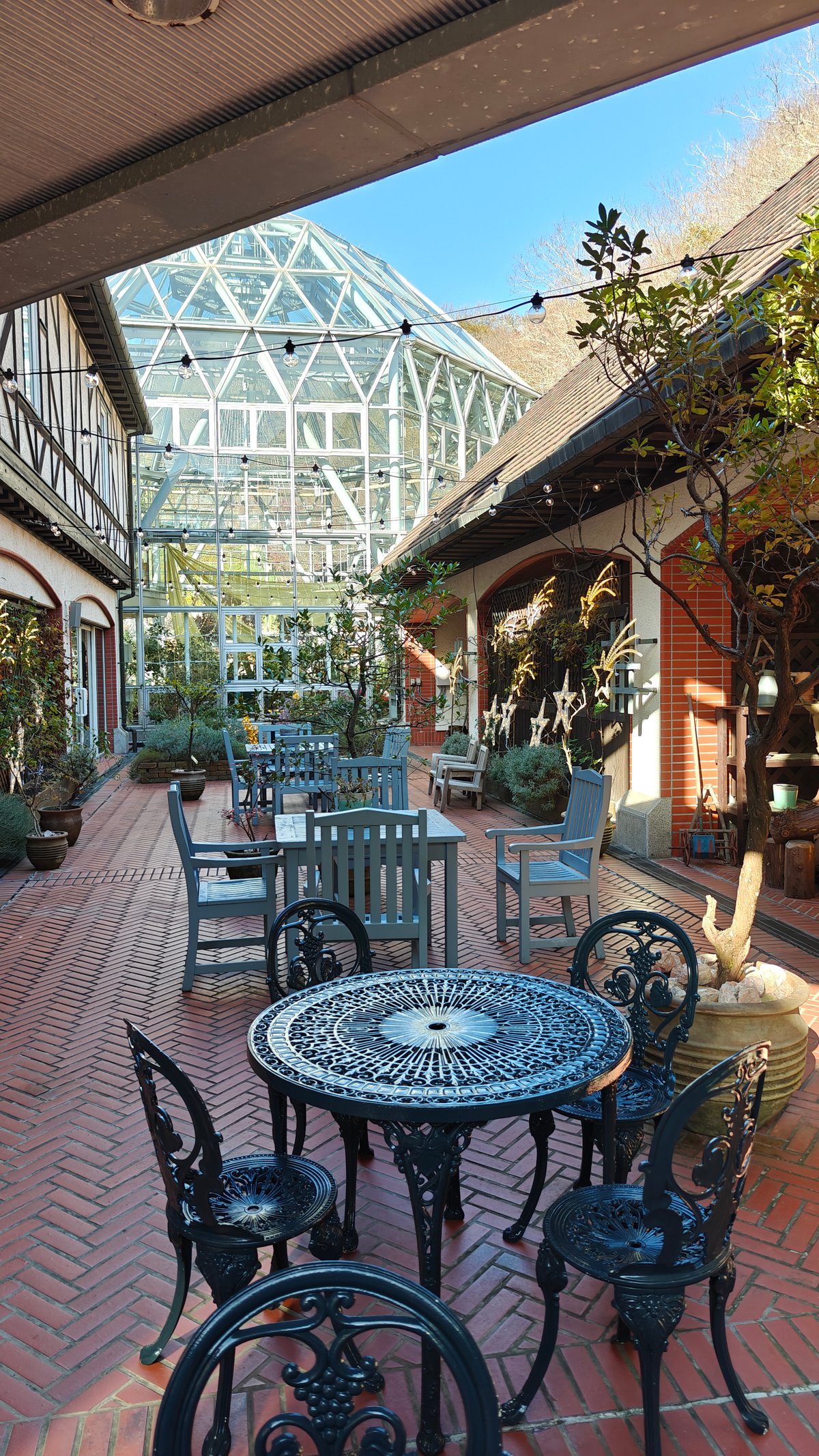 Wrought-iron cafe tables on the terrace beneath the