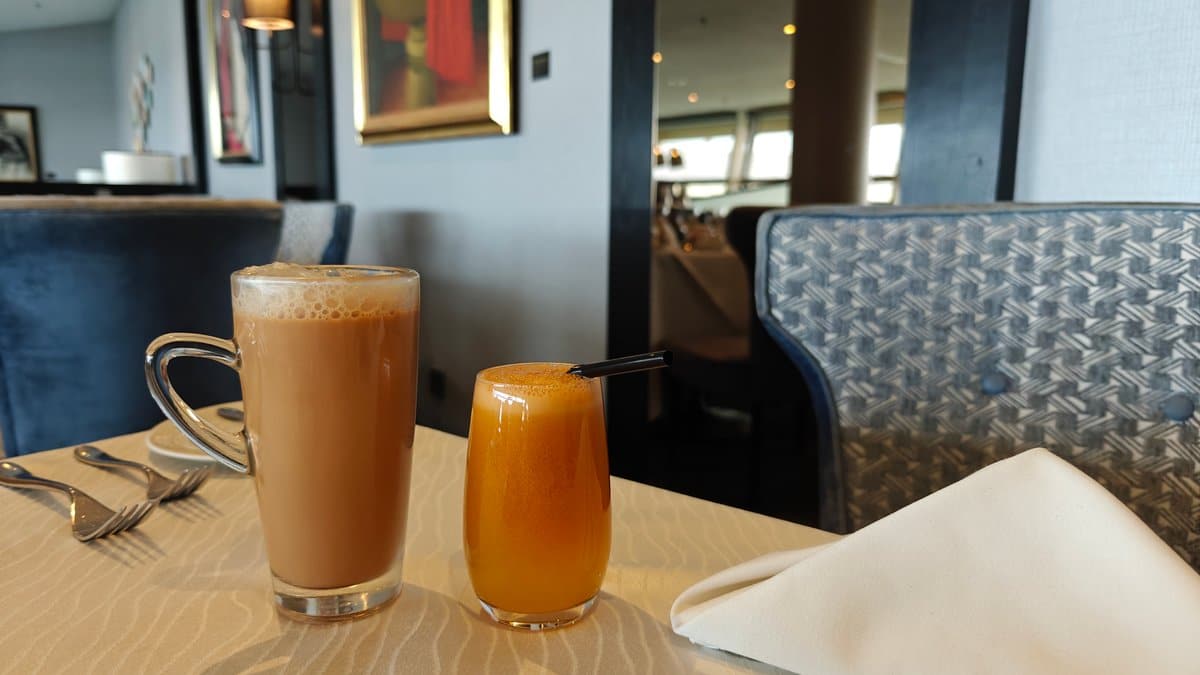 A latte and a glass of orange juice