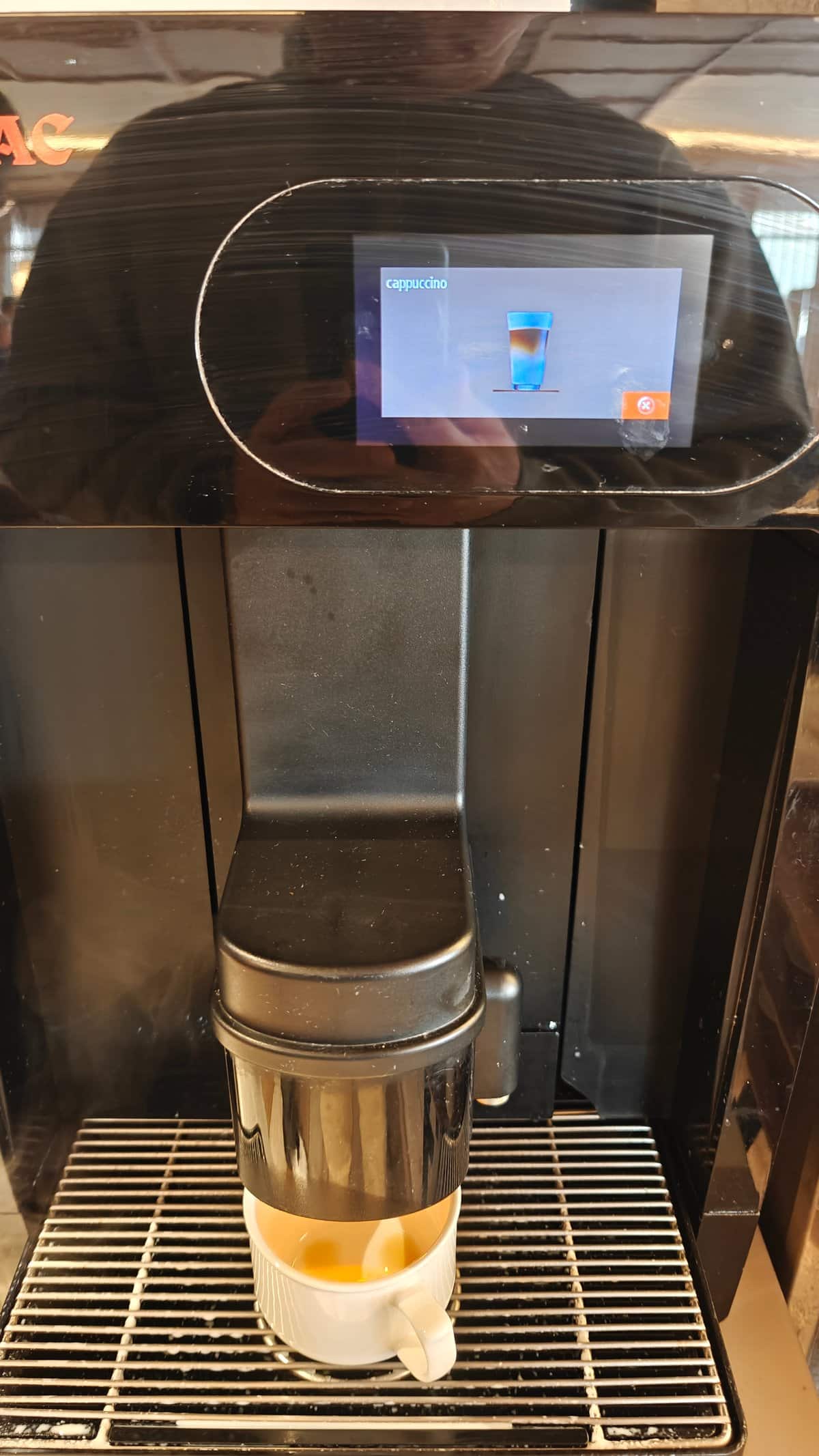 Automatic coffee machine dispensing coffee