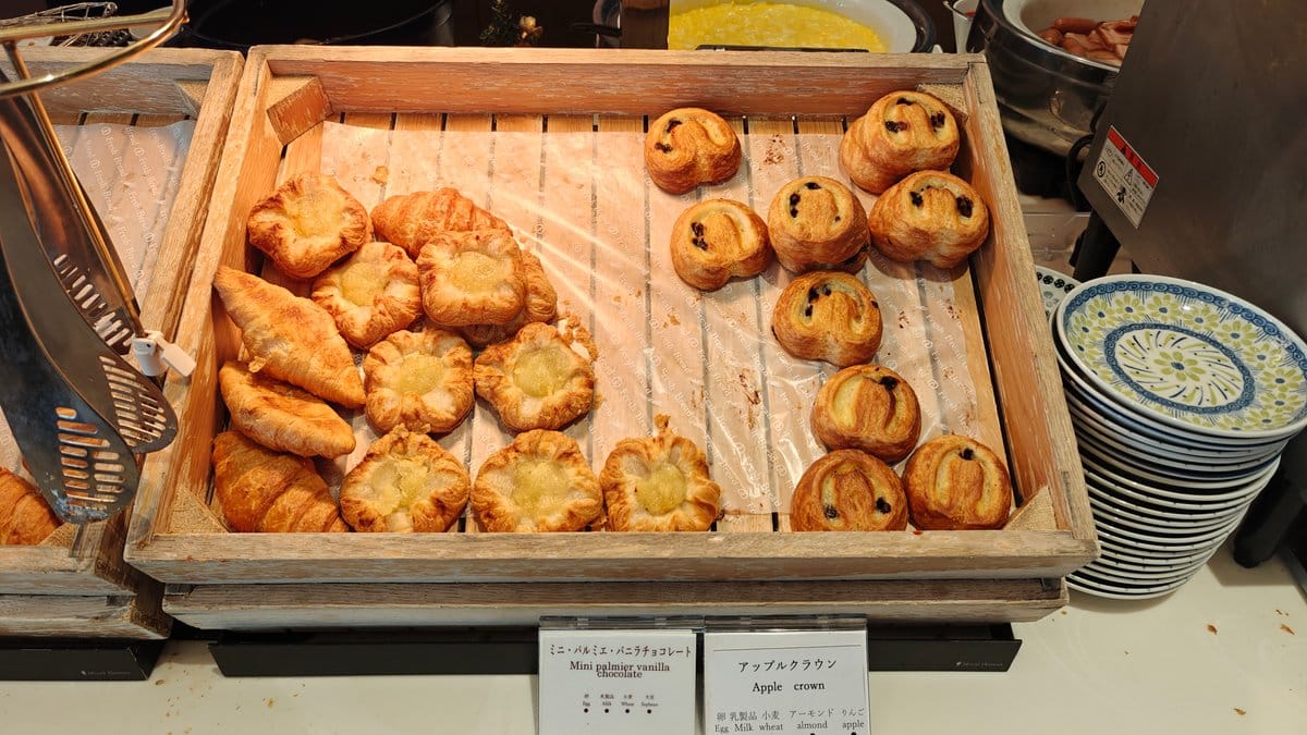 Basket of croissants and danishes on a wooden